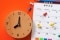 The image shows a clock and a calendar. 
